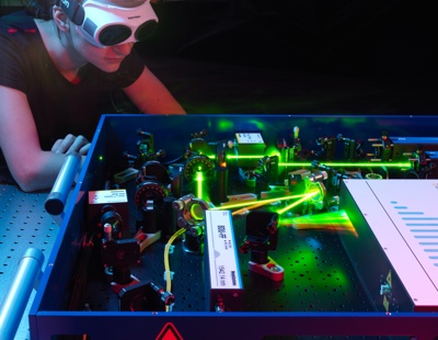 Scientist using laser optics at NPL to measure physical quantities with high precision