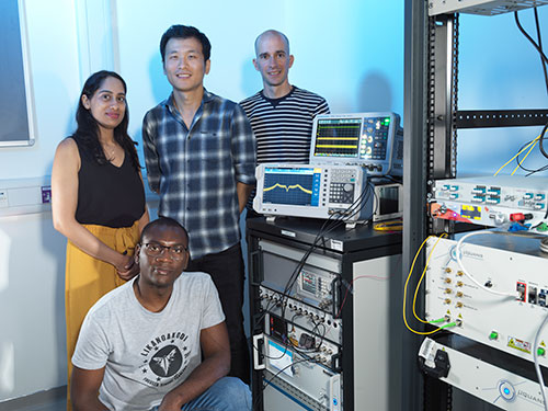 Researchers working with quantum measurement equipment in a laboratory, alongside electronic instrumentation used to test and characterise quantum systems